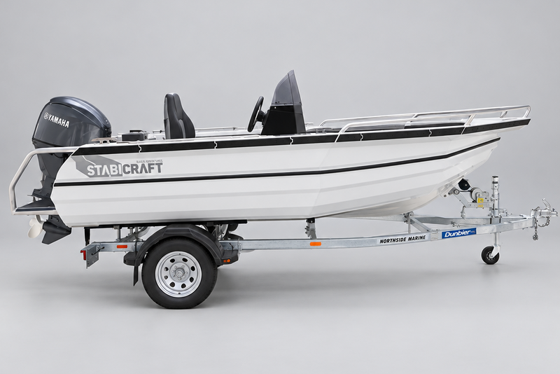 A white Stabcraft boat on a metal trailer parked in front of a Yamaha dealership building.